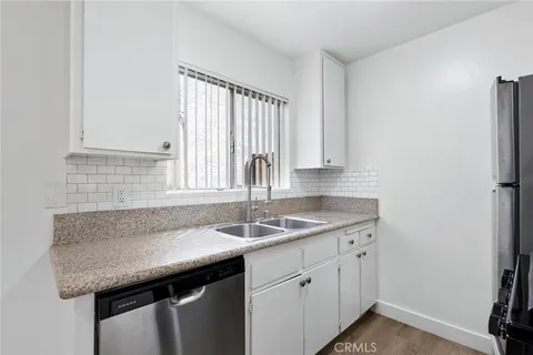 a kitchen that has a sink and a stove