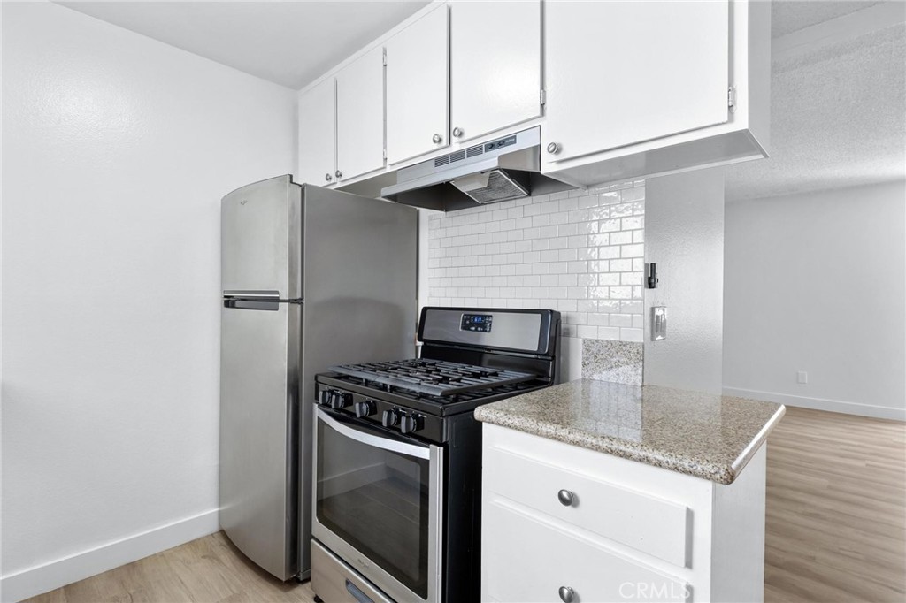 223 Shell Street Manhattan Beach, CA 90266 - Photo 19 of 50 a kitchen with granite countertop a sink stove and refrigerator