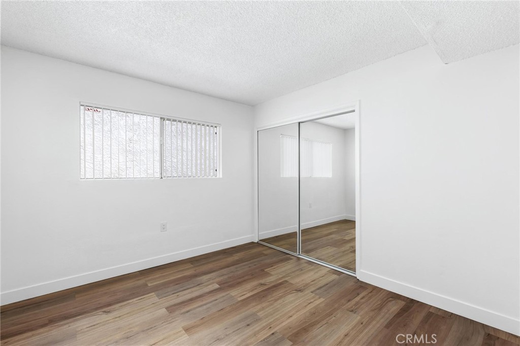 223 Shell Street Manhattan Beach, CA 90266 - Photo 21 of 50 an empty room with wooden floor closet and windows