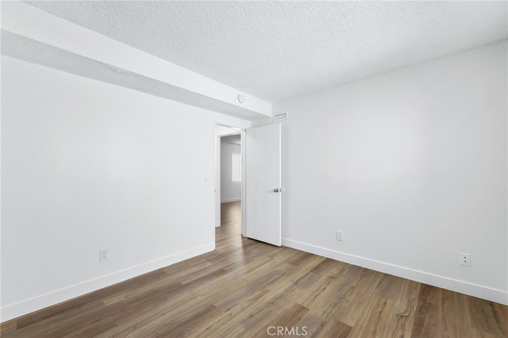 223 Shell Street Manhattan Beach, CA 90266 - Photo 22 of 50 a view of an empty room with wooden floor