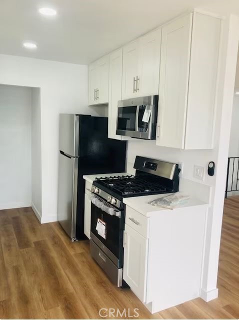 223 Shell Street Manhattan Beach, CA 90266 - Photo 37 of 50 a kitchen with stainless steel appliances a stove a microwave and a refrigerator