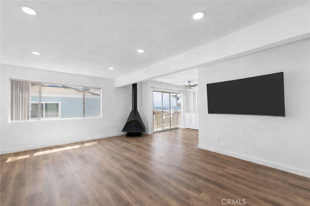 223 Shell Street Manhattan Beach, CA 90266 - Photo 4 of 50 a view of an empty room with wooden floor and a window