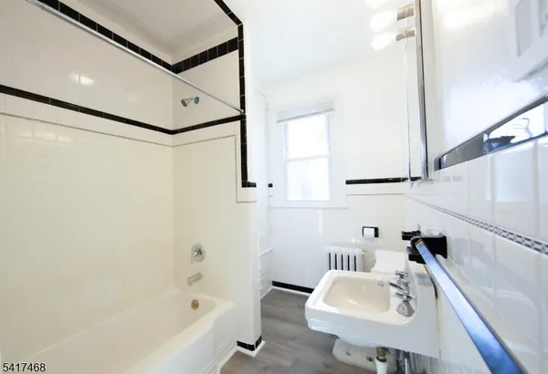 a bathroom with a sink a bathtub and a sink