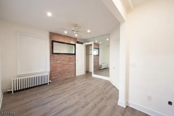 a view of a hallway with wooden floor and glass door