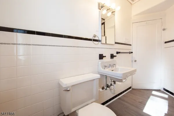 a bathroom with a sink a toilet and mirror