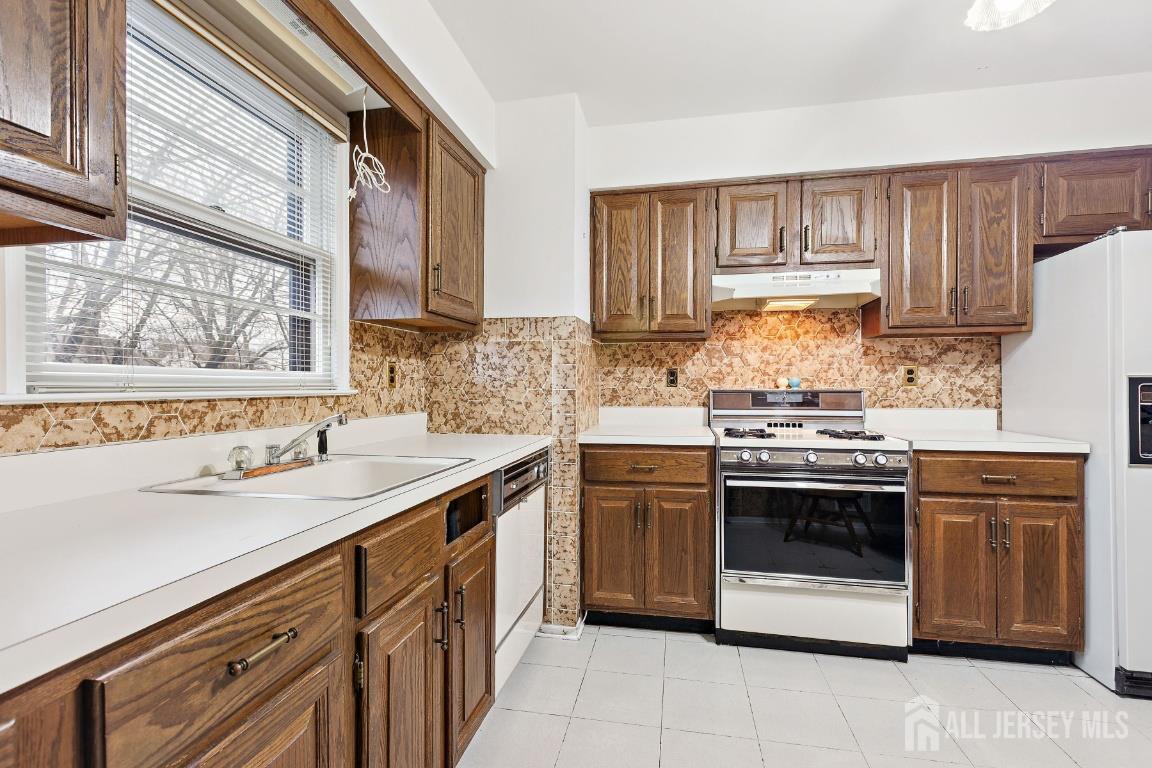 18 Rachele Court Old Bridge, NJ 07747 - Photo 8 of 22 a kitchen with a stove sink and cabinets
