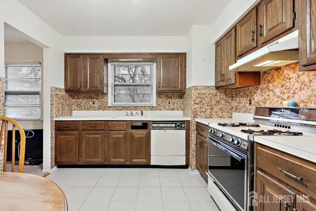 a kitchen with stainless steel appliances granite countertop a stove sink and cabinets