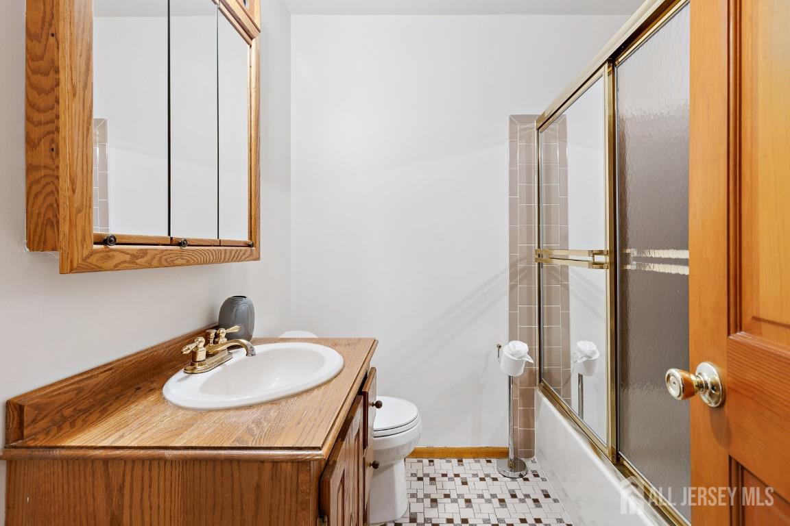18 Rachele Court Old Bridge, NJ 07747 - Photo 10 of 22 a bathroom with a sink and mirror with toilet