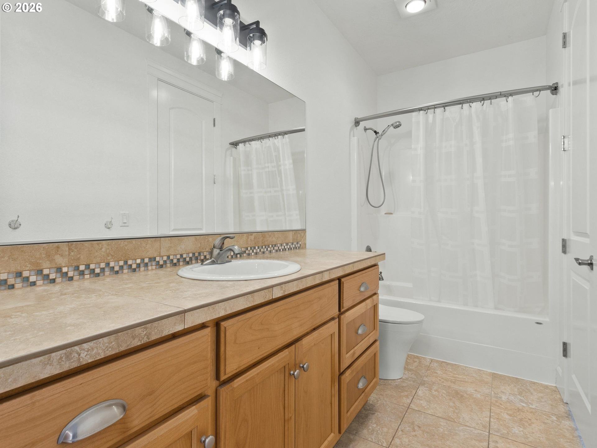1012 Northwest Goodwin Street Camas, WA 98607 - Photo 29 of 44 a bathroom with a granite countertop sink a toilet and shower