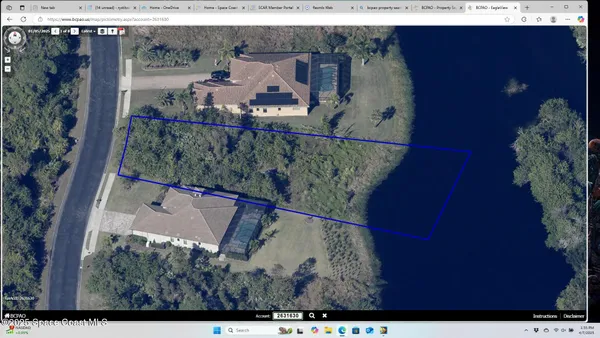 an aerial view of a house with a yard basket ball court and outdoor seating