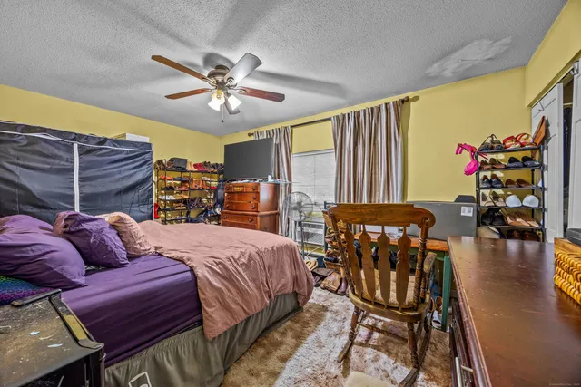 a bedroom with a bed furniture and a chandelier