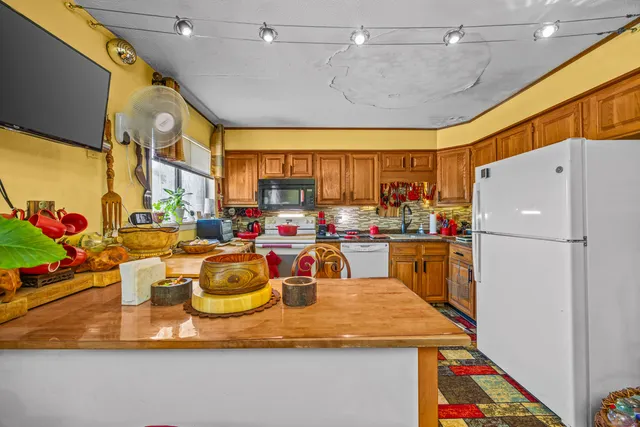 a room with lots of appliances and a kitchen view