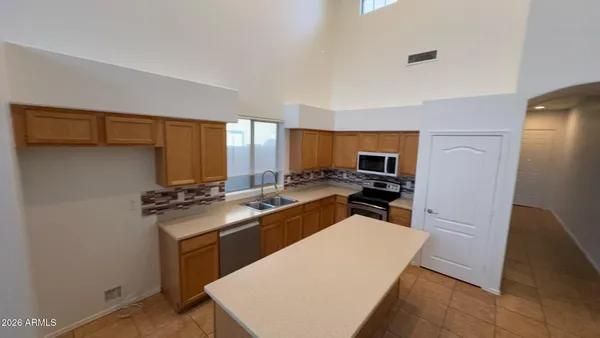 a kitchen with stainless steel appliances a refrigerator and a stove top oven