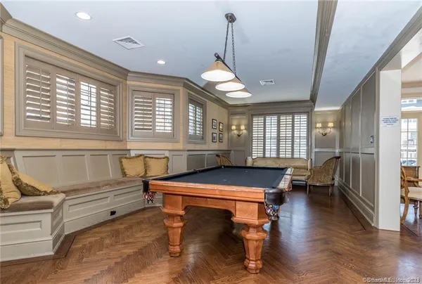 a room with pool table and windows