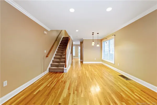 a view of a room with wooden floor and stairs