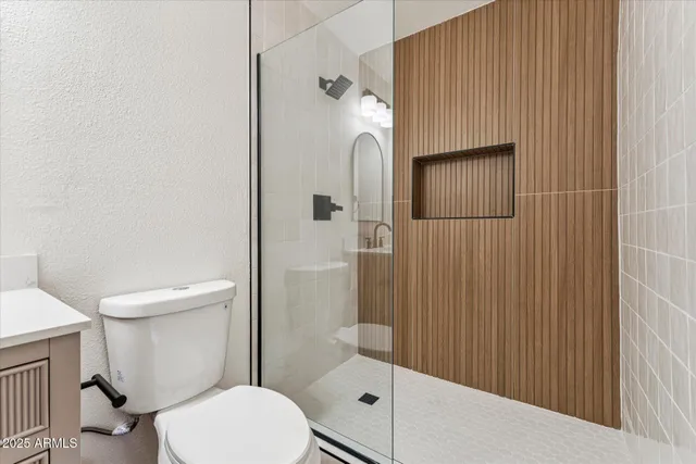 a bathroom with a toilet and a shower