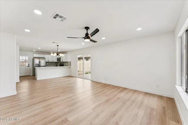 a view of a kitchen with a sink and wooden floor