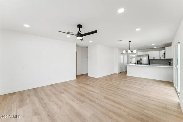 a view of a kitchen with a sink and a refrigerator