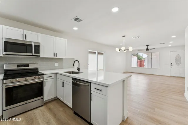 a kitchen with a sink stove and microwave