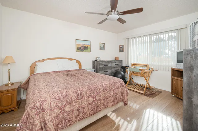 a bedroom with a bed a table and chair