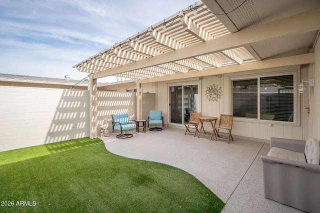a view of a porch with chairs and backyard