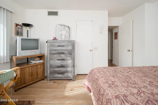 a bedroom with a bed and a television