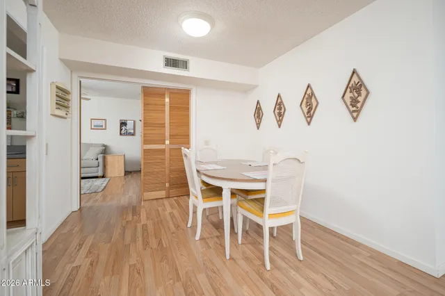 a view of a dining room with furniture and wooden floor