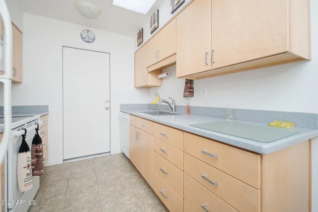 a kitchen with granite countertop white cabinets and a sink
