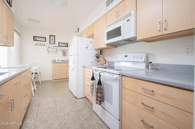 a utility room with cabinets washer and dryer