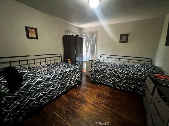 a bed sitting in a bedroom next to a window