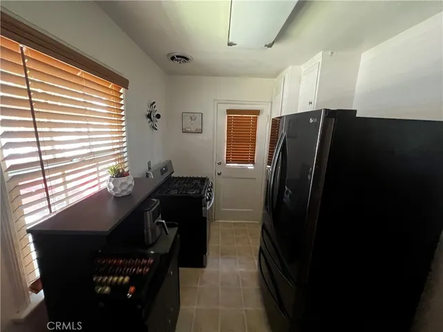 a view of a refrigerator and chair in a room