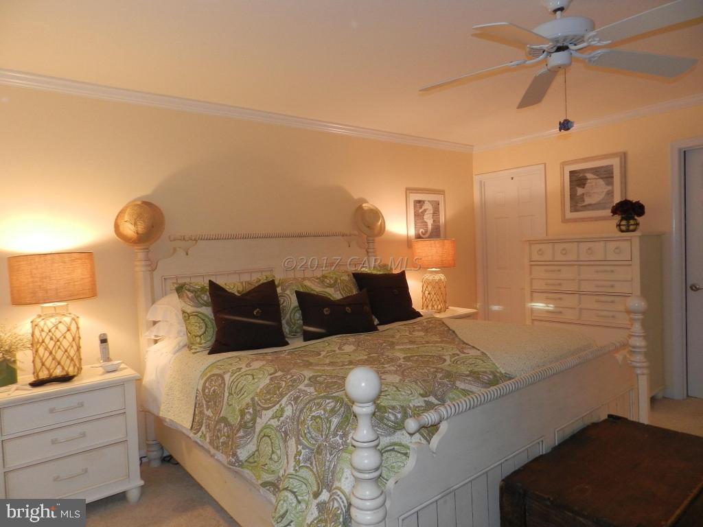 15 Mist Flower Road Berlin, MD 21811 - Photo 4 of 49 a bedroom with a bed and a lamp on the dresser
