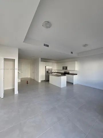 a view of kitchen and kitchen with cabinets
