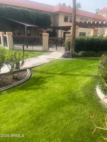 a view of backyard with seating area and green space