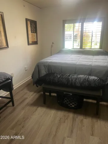a bedroom with a bed and a desk
