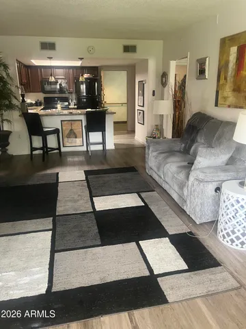 a living room with furniture and view of dining room