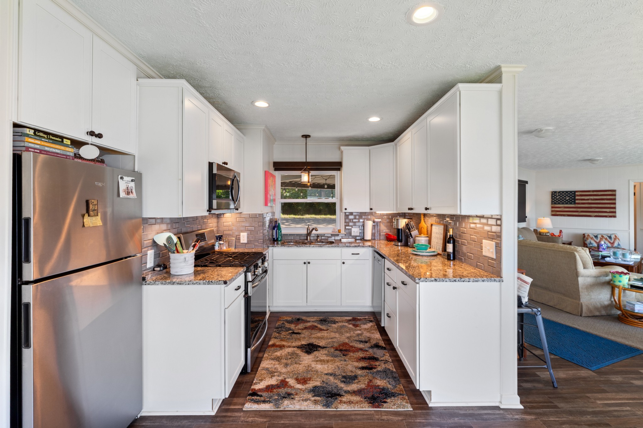 440 Bluff Point Lane Waverly, TN 37185 - Photo 14 of 97 a kitchen with stainless steel appliances granite countertop a refrigerator stove top oven and a sink with wooden floor