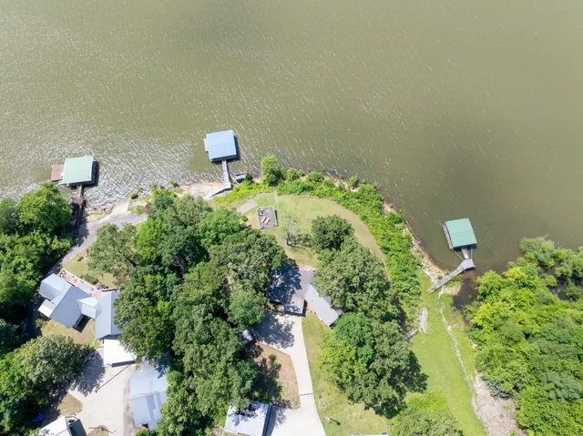 a view of a house with swimming pool and a yard