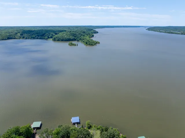 a swimming pool with trees in the background