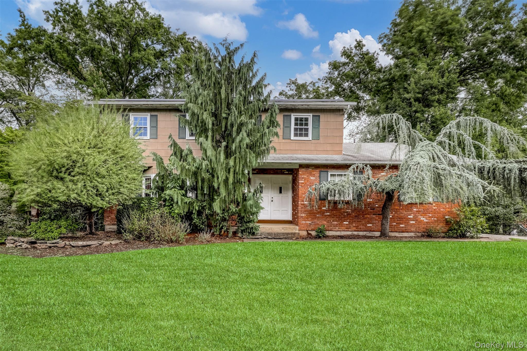 a view of a house with a yard and sitting area