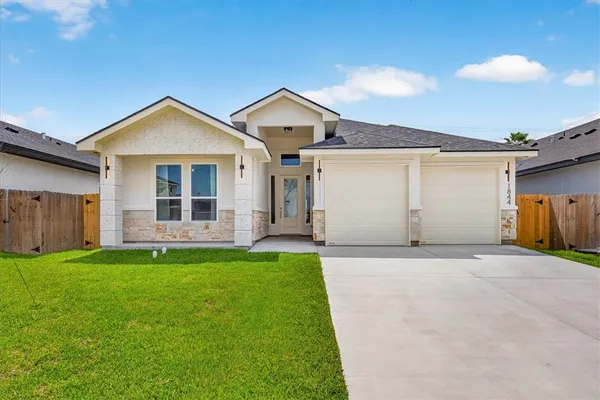 a view of a house with a yard and garage