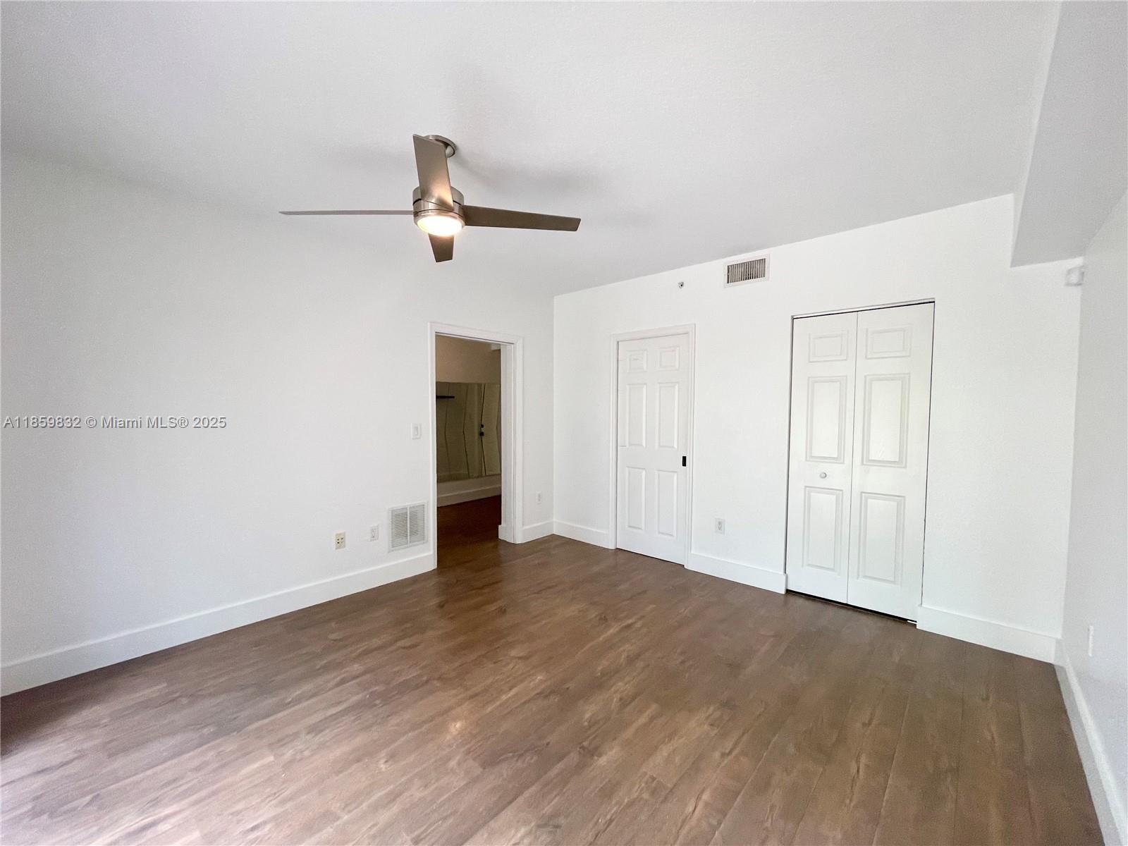 3204 Bird Avenue, Unit 105 Miami, FL 33133 - Photo 14 of 64 a view of empty room with wooden floor