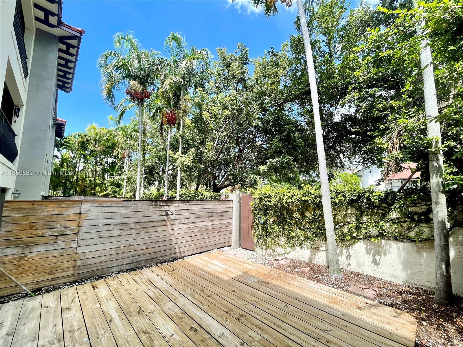 3204 Bird Avenue, Unit 105 Miami, FL 33133 - Photo 18 of 64 a view of a garden with wooden bench