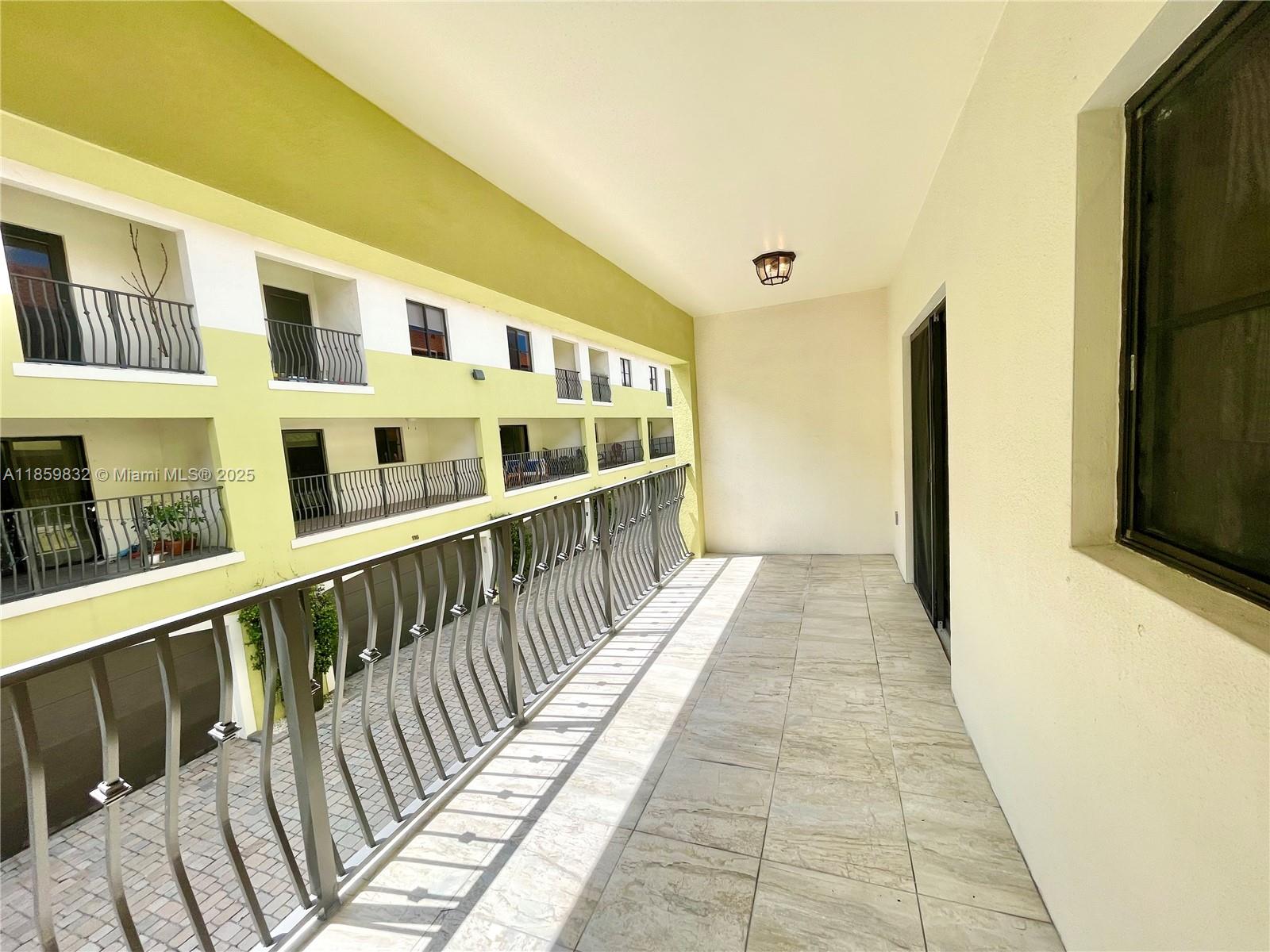 3204 Bird Avenue, Unit 105 Miami, FL 33133 - Photo 39 of 64 a view of a balcony with wooden floor
