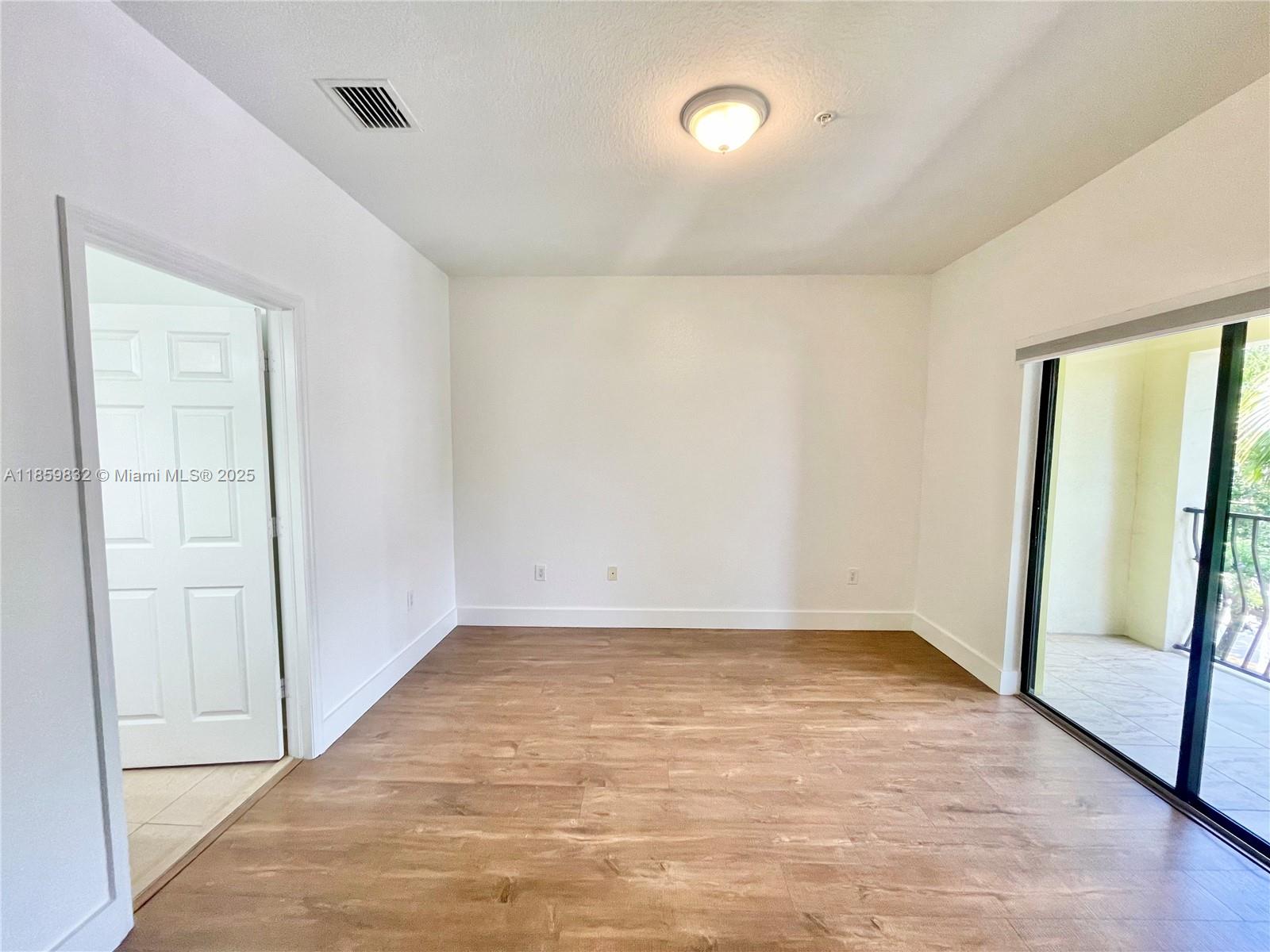 3204 Bird Avenue, Unit 105 Miami, FL 33133 - Photo 46 of 64 wooden floor in an empty room with a window