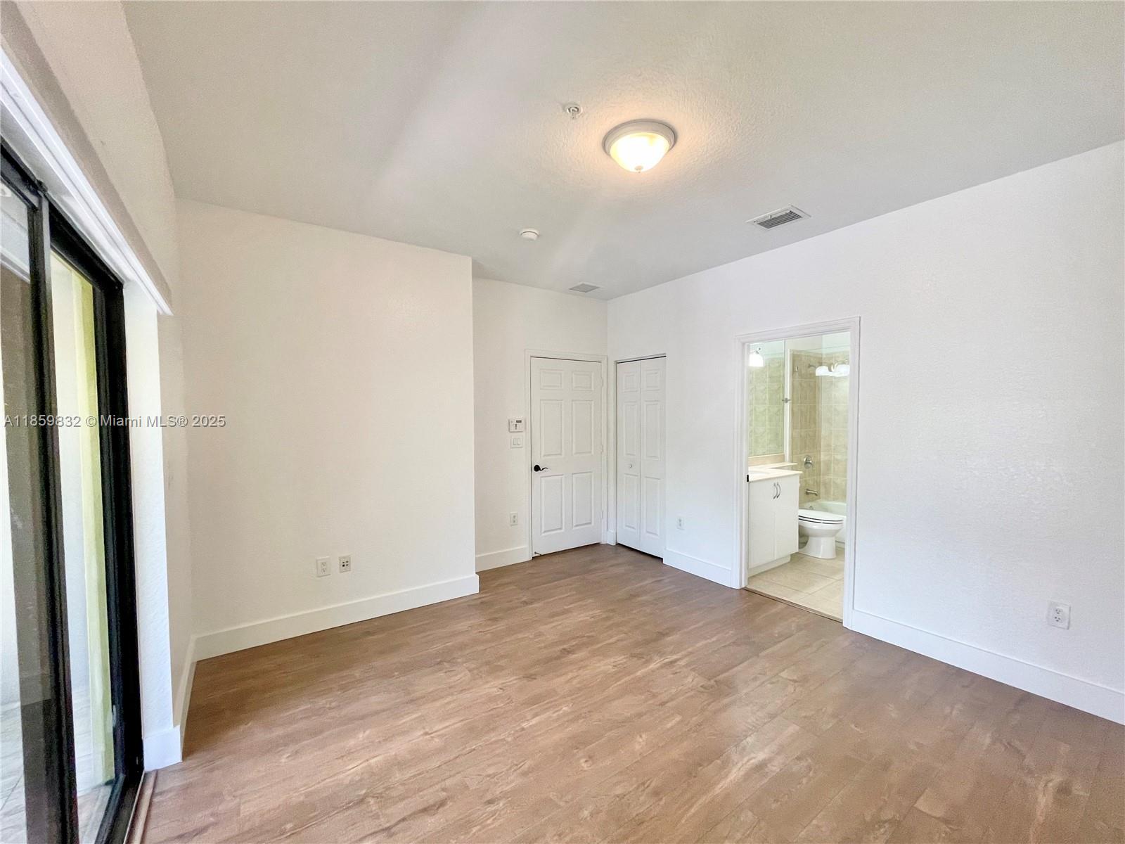 3204 Bird Avenue, Unit 105 Miami, FL 33133 - Photo 49 of 64 an empty room with a natural light