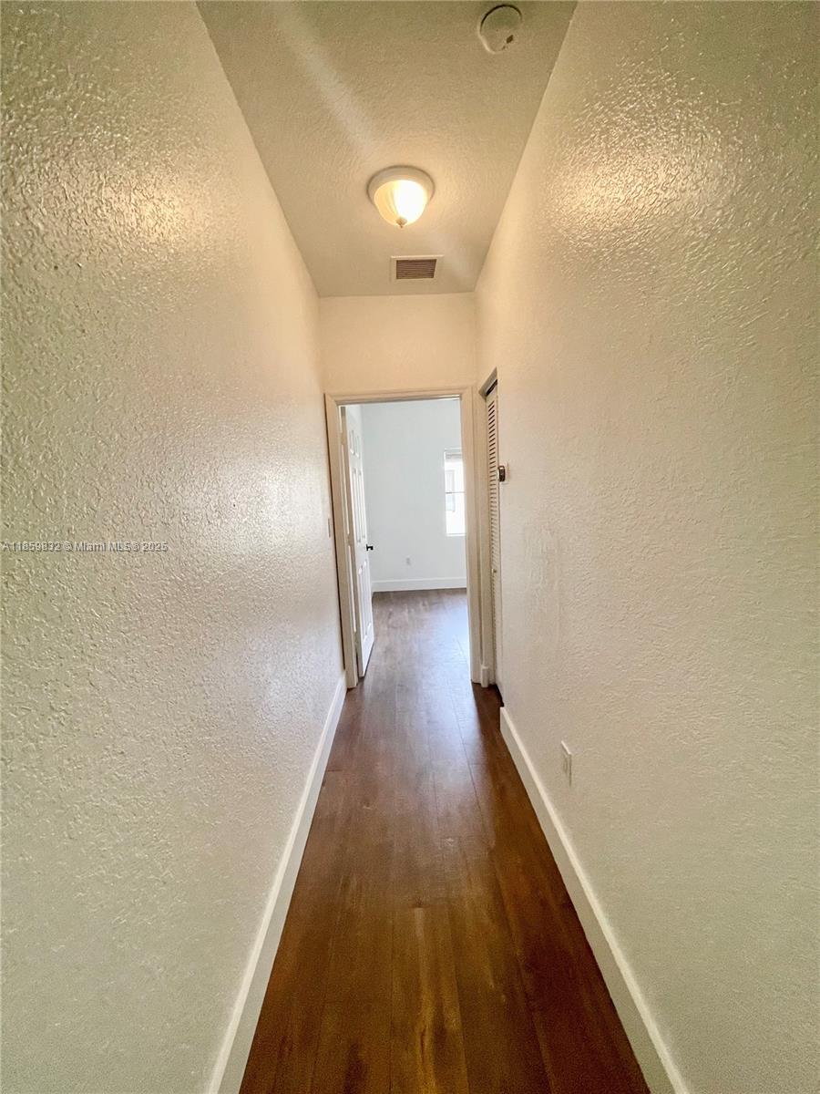 3204 Bird Avenue, Unit 105 Miami, FL 33133 - Photo 55 of 64 a view of a hallway with wooden floor