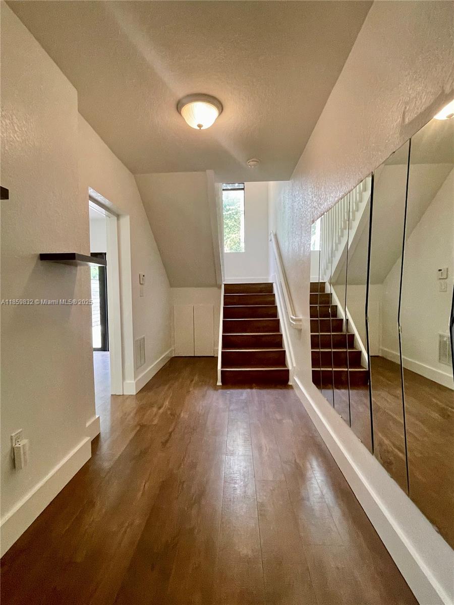 3204 Bird Avenue, Unit 105 Miami, FL 33133 - Photo 8 of 64 a view of entryway and hall with wooden floor