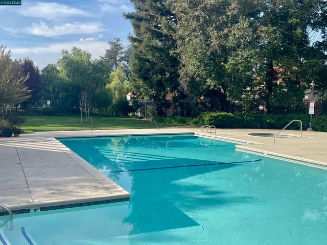 a view of a swimming pool with a yard
