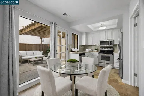 a kitchen with a table chairs stove and refrigerator